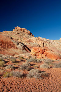 Scenic view of mountains against clear blue sky