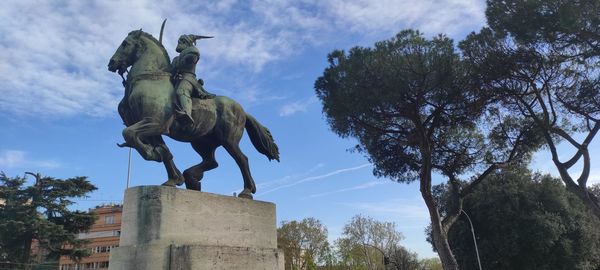 Low angle view of statue against sky