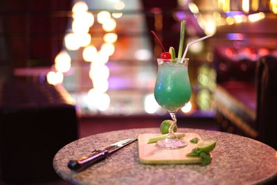 Cocktail served on table in illuminated restaurant