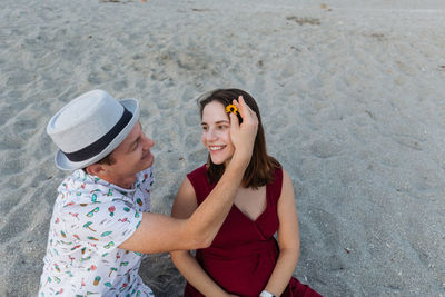  portrait of young pregnant woman with husband looking at each other