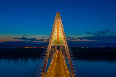 Aerial view of the beautiful illuminated megyeri bridge over river danube at sunset