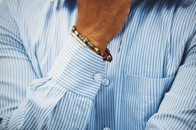 View of person wearing formal stripped shirt