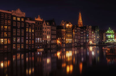 Reflection of illuminated buildings in city at night