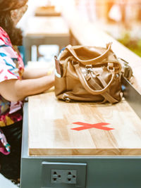 Close-up of woman holding umbrella on table