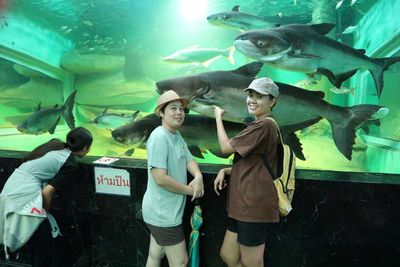 Group of people in fish tank at aquarium