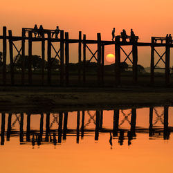 Silhouette bridge against sky during sunset