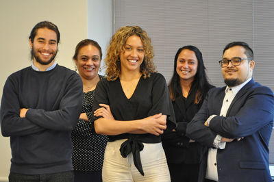 Business colleagues standing against wall