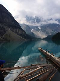 Scenic view of lake by mountains against sky