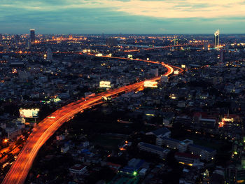 Illuminated street in city at dusk