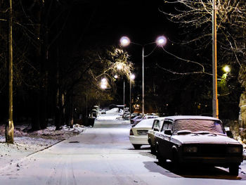 Car on illuminated street during winter at night