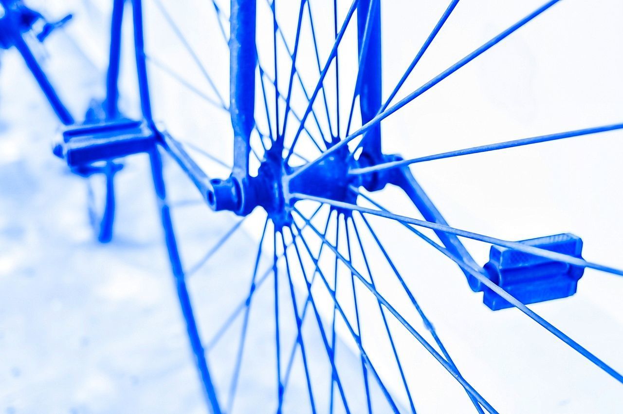 LOW ANGLE VIEW OF BLUE METALLIC STRUCTURE AGAINST SKY