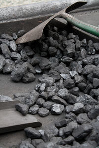 High angle view of coals and shovel