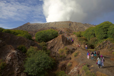 Tourists hiking towards volcano