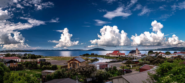 High angle view of townscape by sea against sky