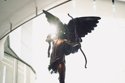 Low angle view of butterfly hanging on ceiling