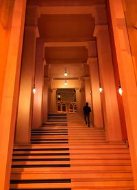 People walking in illuminated building