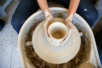 High angle view of person making pottery