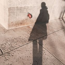 High angle view of man walking with umbrella