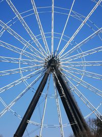 Low angle view of ferris wheel against blue sky
