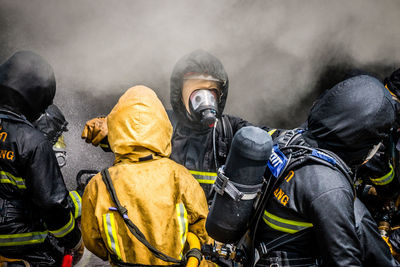 Firefighter spraying water on fire