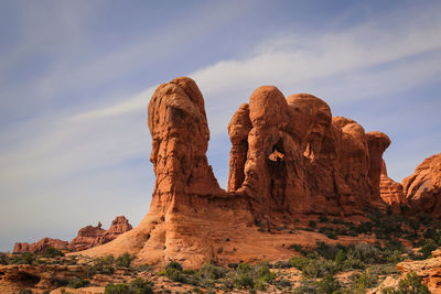 Rock formation on mountain against cloudy sky