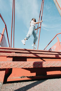 Low angle view full length of man skateboarding on field