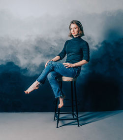 Portrait of young woman sitting on chair