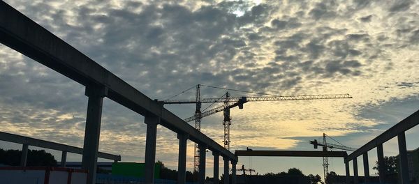 Low angle view of silhouette bridge against sky