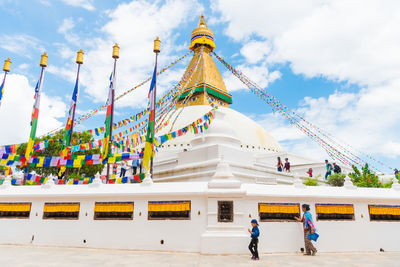 People at temple against building