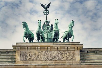 Low angle view of statue against cloudy sky