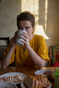 Portrait of a boy drinking coffee