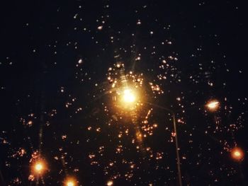 Low angle view of firework display at night