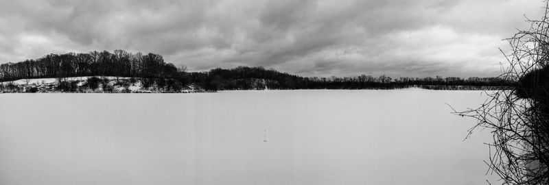 Scenic view of lake against sky during winter