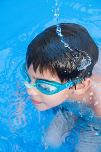 High angle view of boy swimming in pool