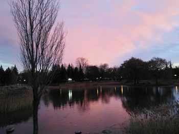 Scenic view of lake against sky at sunset