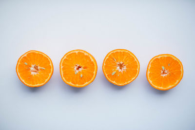 Close-up of orange slices over white background