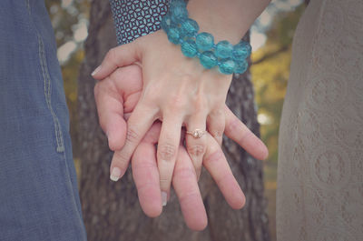 Close-up of couple holding hands