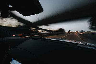 Close-up of car moving on road