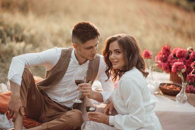 Young couple sitting at park