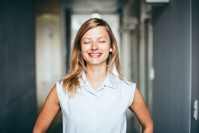 Portrait of a smiling young woman with her eyes closed