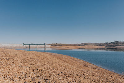 Scenic view of field against clear blue sky