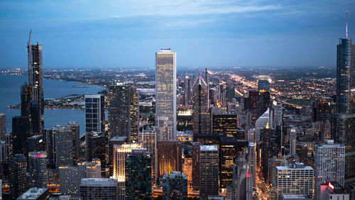 Aerial view of modern buildings in city against sky