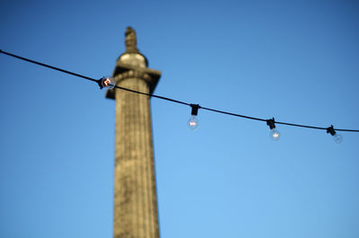 Low angle view of street light against clear blue sky