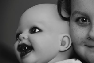 Cropped portrait of girl with spooky doll