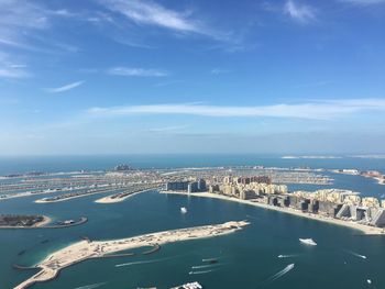 High angle view of buildings by sea against sky