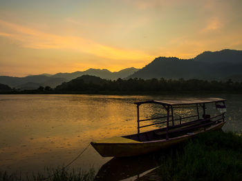 Scenic view of lake against sky during sunset