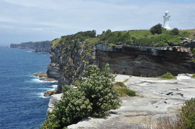 Scenic view of sea by buildings against sky