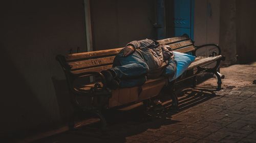 Man sleeping on chair in house