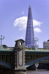 View of bridge and buildings against sky