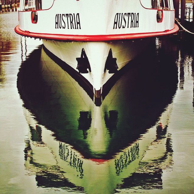 water, text, reflection, built structure, transportation, architecture, western script, railing, day, outdoors, in a row, waterfront, no people, communication, sea, building exterior, river, guidance, canal, nautical vessel